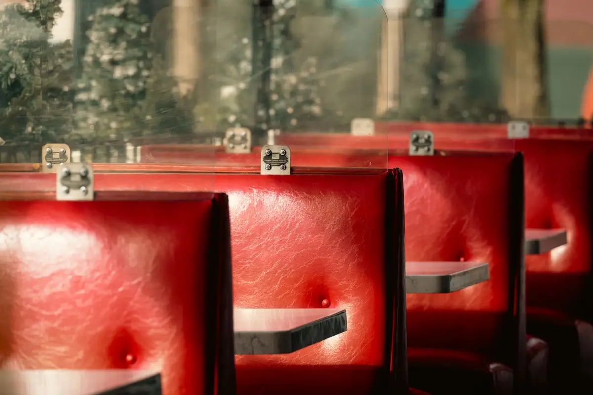 Row of red leather booths along the windows of a classic diner