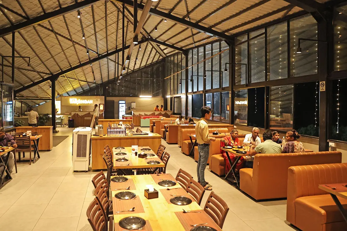 Large family restaurant dining room with long tables and booth seating